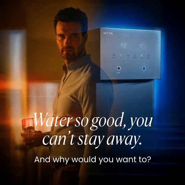 An advertisement for the NECOA water dispenser, featuring a man holding a glass of water next to a modern, wall-mounted digital dispenser. The ad is styled with contrasting warm amber and cool blue lighting, with overlay text reading, 'Water so good, you can't stay away. And why would you want to?'