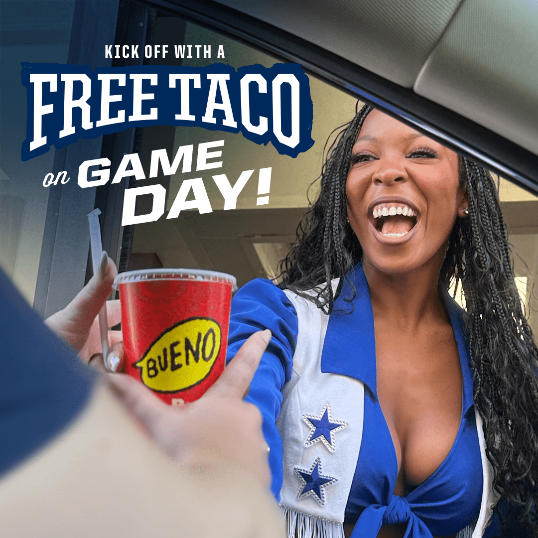 An excited woman in a cheerleader outfit smiles broadly at a drive-thru window as she receives a red Taco Bueno cup. Text overlay reads, 'KICK OFF WITH A FREE TACO on GAME DAY!'