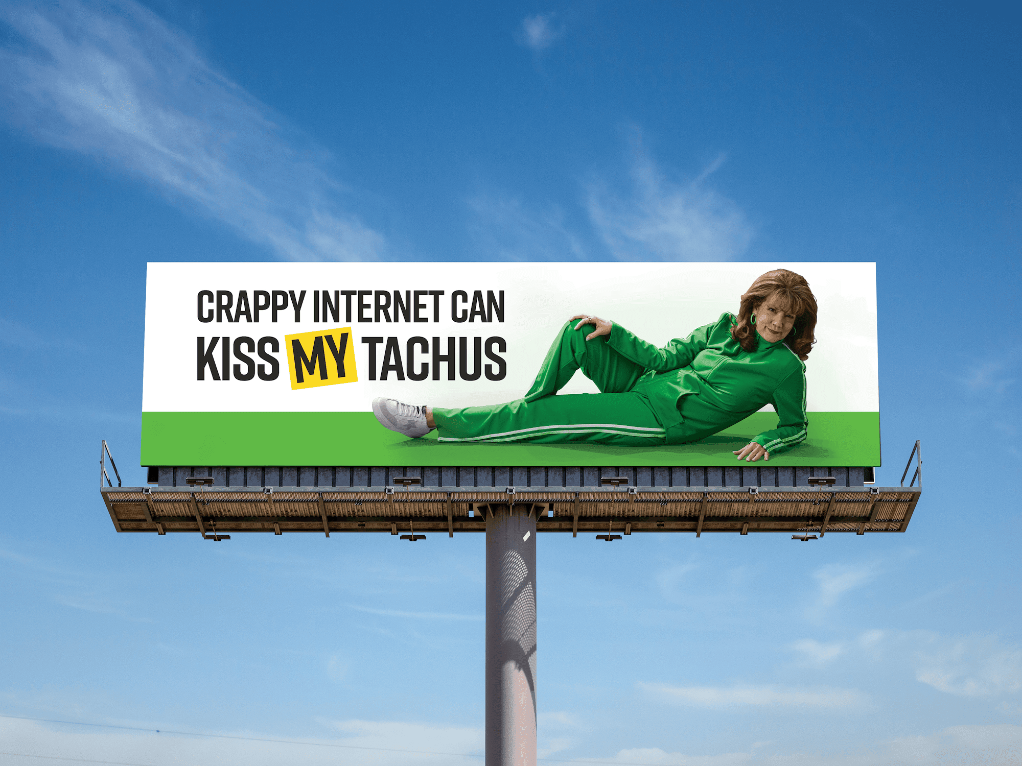 A woman in a green tracksuit is reclining on a billboard. The billboard has white text stating 'CRAPPY INTERNET CAN KISS MY TACHUS'.