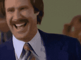 Will Ferrell as Ron Burgundy from the movie Anchorman, laughing heartily in a blue suit with a wide-open smile.